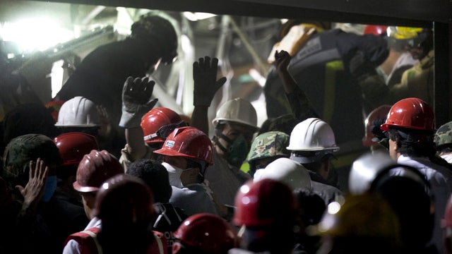 Rescue workers, firefighters and military search for survivors at site of explosion in headquarters of Mexico's state-owned oil company, PEMEX, in Mexico City on Jan. 31, 2013. The explosion killed at least 25 people and injured more than 100. 