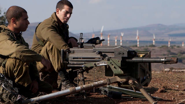 Israeli soldiers man an abandoned military outpost overlooking the ceasefire line between Israel and Syria 