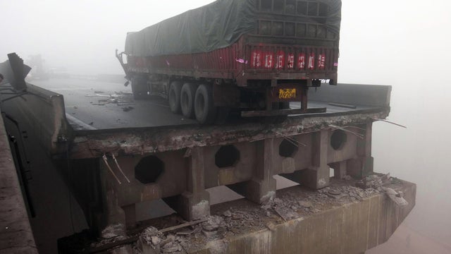 Photo provided by China's Xinhua News Agency shows truck sitting on highway bridge that partially collapsed due to explosion in truck carrying fireworks in Mianchi County, Sanmenxia, central China's Henan Province, on Feb. 1, 2013, killing at least four p 