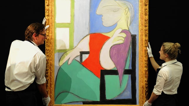 File photo dated Jan. 31, 2013 shows gallery assistants hanging Picasso's "Femme Assise Pres d'une Fenetre" (Woman Sitting Near a Window), which sold for nearly $45 million at auction on Feb. 5, 20123. It is a portrait of his "golden muse," Marie-Therese  