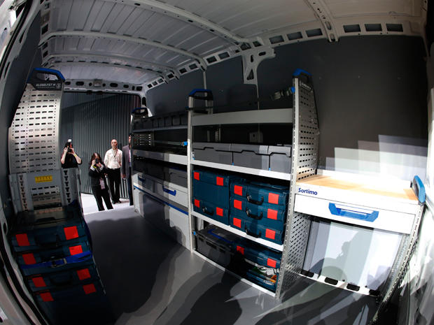 A crowd of people eyes the spacious interior of Chrysler's new cargo van, the 2014 Ram ProMaster 3500, on February 7, 2013, in a preview of the Chicago Auto Show. 