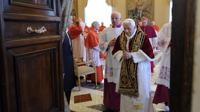 Pope Benedict XVI leaves a meeting after announcing his pending resignation at the Vatican 