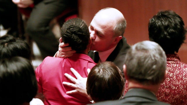 French Justice Minister Christiane Taubira (C) is congratulated by the President of the socialist group at the French National Assembly, Bruno Le Roux (C,R) following her speech on February 12, 2013 at the National Assembly in Paris, after the assembly vo 