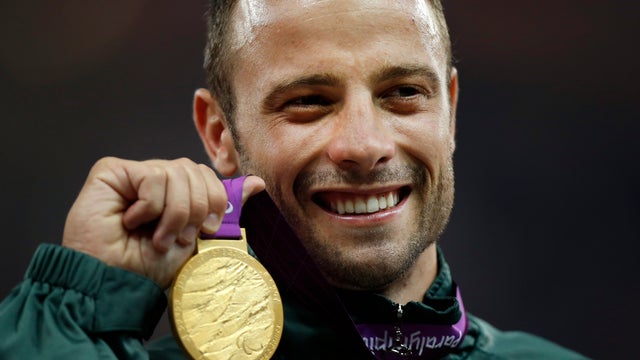 Gold medalist South Africa's Oscar Pistorius poses with his medal after winning the men's 400 meters T44 category final during the 2012 Paralympics in London Sept. 8, 2012. 