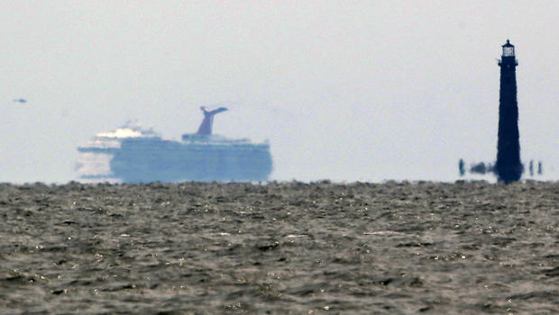 The cruise ship Carnival Triumph is visible several miles beyond the Sand Island Light House near Dauphin Island, Ala., Thursday, Feb. 14, 2013. 