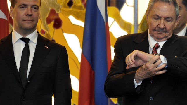 Cuban President Raul Castro, right, looks at his watch beside Russian Prime Minister Dmitry Medvedev during the signing of bilateral agreements Feb. 21, 2013, in Havana. 