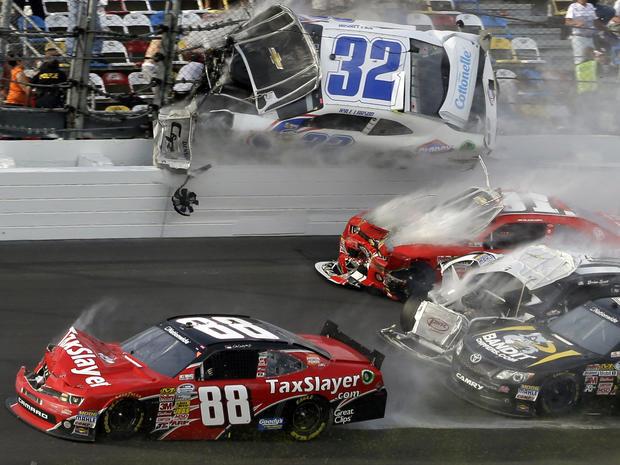 Kyle Larson (32) goes airborne into the catch fence in a multi-car crash that includes Dale Earnhardt Jr. (88), Parker Kilgerman (77), Justin Allgaier (31) and Brian Scott (2) during the final lap of the NASCAR Nationwide Series auto race at Daytona Inter 