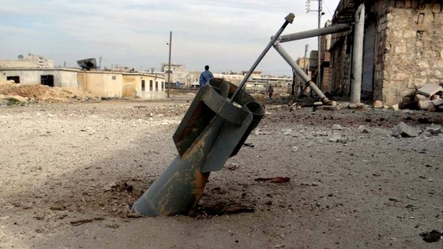 Citizen journalism image provided by Aleppo Media Center AMC, which has been authenticated based on its contents and other AP reporting, shows unexploded rocket from a Syrian warplane, in the neighborhood of Karam Alqasir, near Aleppo International Airpor 