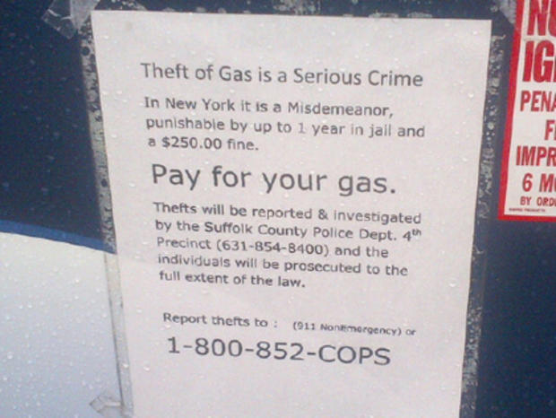 Sign warning against stealing gas 