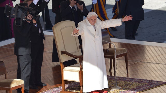 Pope Benedict XVI waves from the altar as he arrives on St. Peter's square for his last weekly audience 