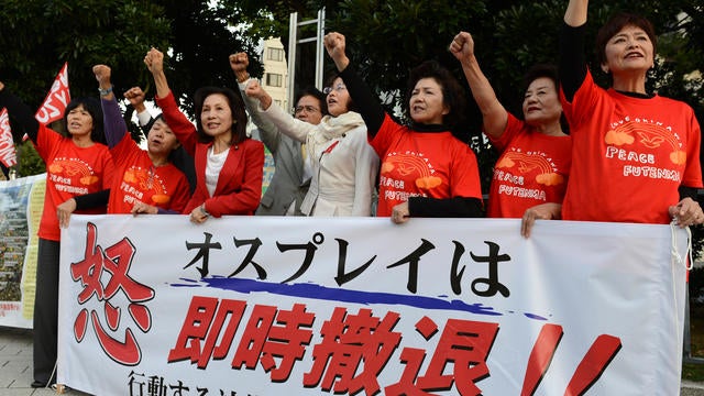 Lawmakers and city council members from Okinawa shout slogans during protest against U.S. military bases in Okinawa in front of prime minister's official residence in Tokyo on Oct. 24, 2012. Okinawa Governor Hirokazu Nakaima was visiting Washington for pr 
