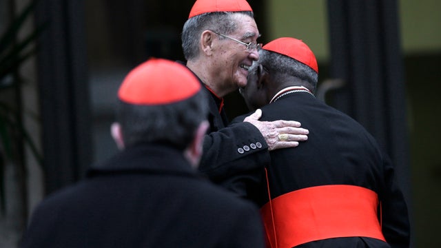 Vietnamese Cardinal Jean-Baptiste Pham Minh Man, center, greets an unidentified cardinal as he arrives for a meeting at the Vatican 