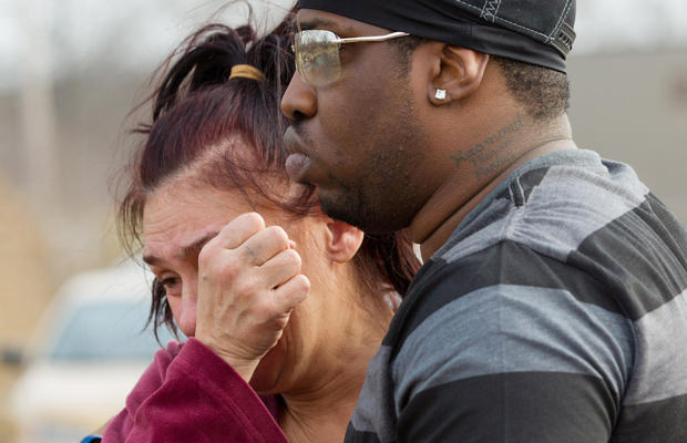 Kasmond Parker, right, consoles Cyndy Mann at the crash site where six teens were killed early in the morning on Park Ave. in Warren, Ohio on Sunday, March 10, 2013. 