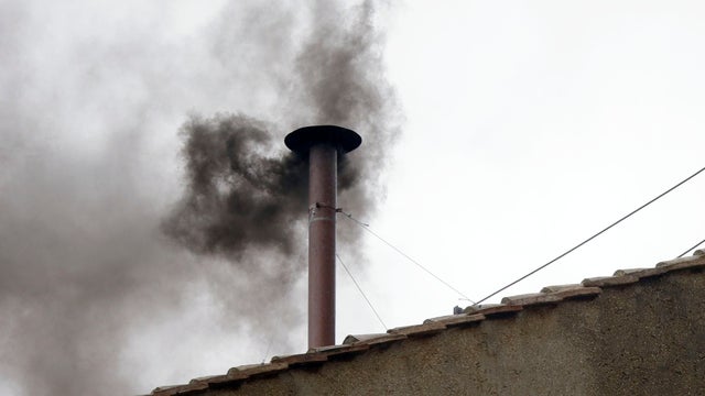 Black smoke emerges from the chimney on the roof of the Sistine Chapel, in St. Peter's Square at the Vatican, March 13, 2013.  