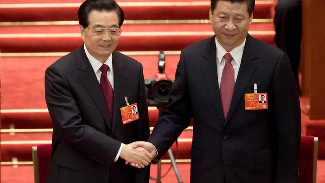 Newly-named Chinese President Xi Jinping, right, poses with outgoing President Hu Jintao at plenary session of the National People's Congress held at Great Hall of the People in Beijing March 14, 2013 