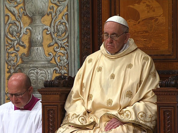 Pope Francis sits on the papal throne in the Sistine Chapel  
