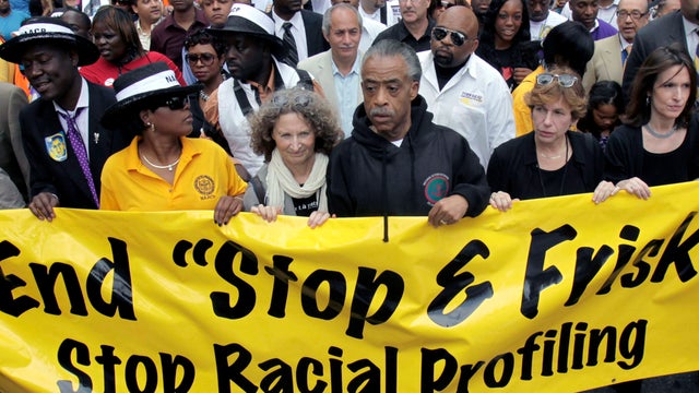 In this June 17, 2012 file photo, Rev. Al Sharpton, center, walks with thousands along Fifth Avenue, during a silent march to end the "stop-and-frisk" program in New York. 