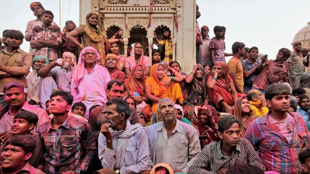 Indian Hindu devotees wait outside the Ladali, or Radha, temple during the Lathmar Holy festival in the legendary hometown of Radha, consort of Hindu god Krishna, in Barsana, India, 71 miles from New Delhi, March 21, 2013. 