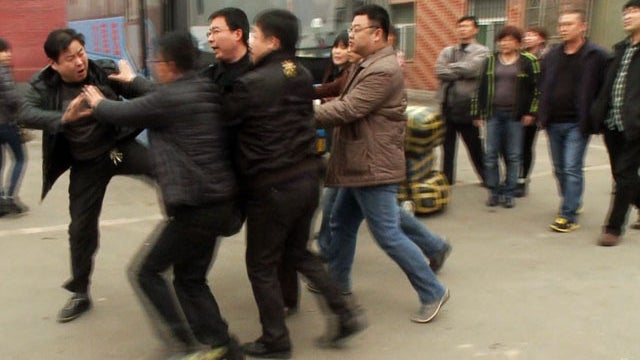 In Zhengzhou, China, protesters are determined to confront the station's manager for skimming profits. 