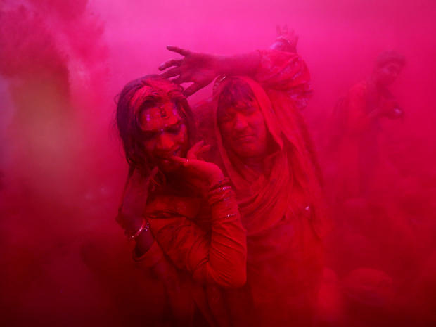 Hindu transsexuals, or eunuchs, dance as colored powder is thrown at the Ladali, or Radha, temple before the procession for the Lathmar Holi festival in the legendary hometown of Radha, consort of Hindu god Krishna, in Barsana, India, 71 miles from New De 