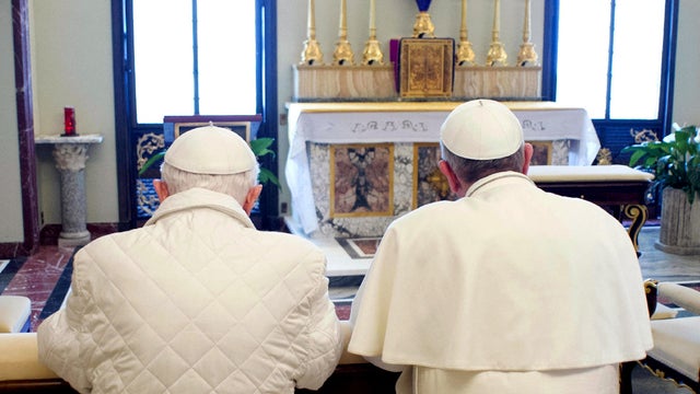 Pope Francis, right, and Pope Emeritus Benedict pray together in Castel Gandolfo, Italy, March 23, 2013, in this picture provided by the Vatican paper L'Osservatore Romano. 