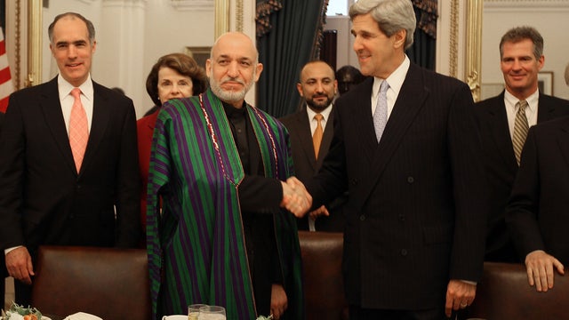  Afghan President Hamid Karzai shakes the hand of Sen. John Kerry, May 13, 2010 