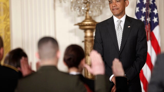 President Barack Obama, watches as the Oath of Allegiance is administered at a naturalization ceremony for active duty service members and civilians, March 25, 2013, in the East Room of the White House in Washington.  