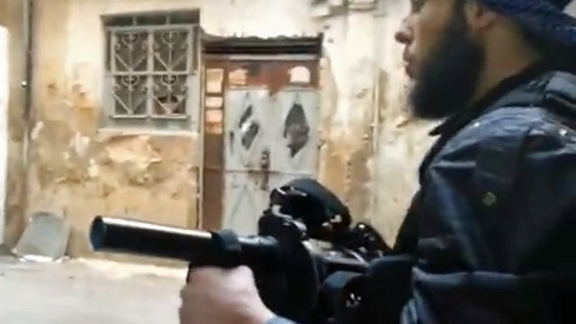Syrian rebel holds a grenade launcher in the southern Damascus suburbs 
