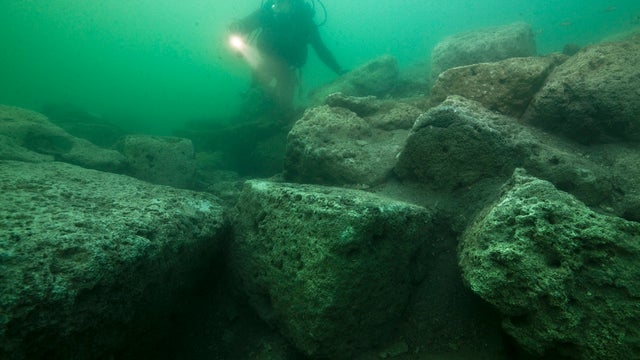A diver inspects limestone blocks on the seabed of the harbor of Alexandria, Egypt, on May 25, 2010.  