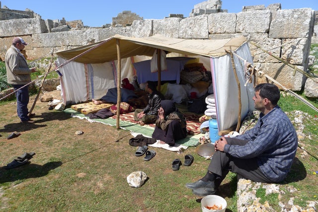 Hundreds of Syrians have fled life in the nation's heavily-bombed cities to try and dodge the artillery in ancient Roman ruins 