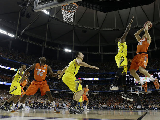 Syracuse's Brandon Triche (20) shoots against a Michigan defense during the first half of a NCAA Final Four tournament college basketball semifinal game April 6, 2013, in Atlanta. 