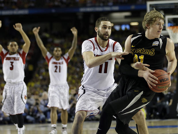 Wichita State's Ron Baker (31) and Louisville's Luke Hancock move during the second half of a NCAA Final Four tournament college basketball semifinal game April 6, 2013, in Atlanta. Louisville won 72-68. 