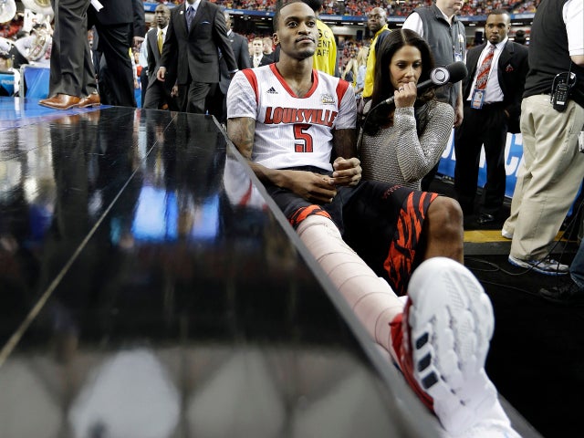 Louisville's Kevin Ware sits on the bench at the court before the first half of a NCAA Final Four tournament college basketball semifinal game against Wichita State April 6, 2013, in Atlanta. 