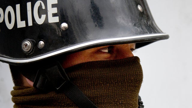 An Afghan policeman stands guard in central Kabul, Saturday, April 6, 2013.  