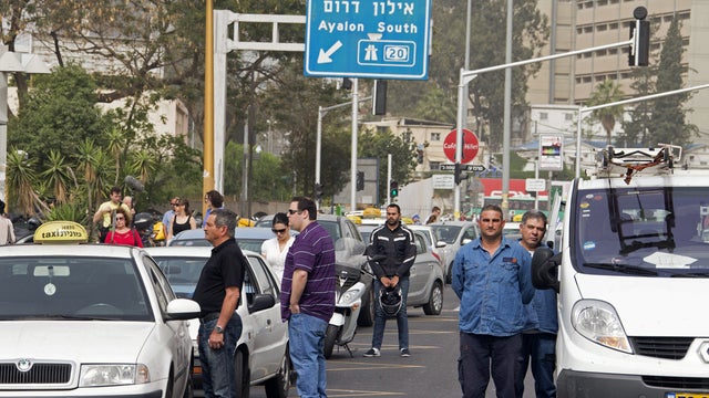 Israelis stop their vehicles and stand in silence in Tel Aviv April 8, 2013, as sirens sound across the country for two minutes in memory of Holocaust victims. Israel began marking Holocaust Martyrs and Heroes Remembrance Day at sundown on April 7 with a  