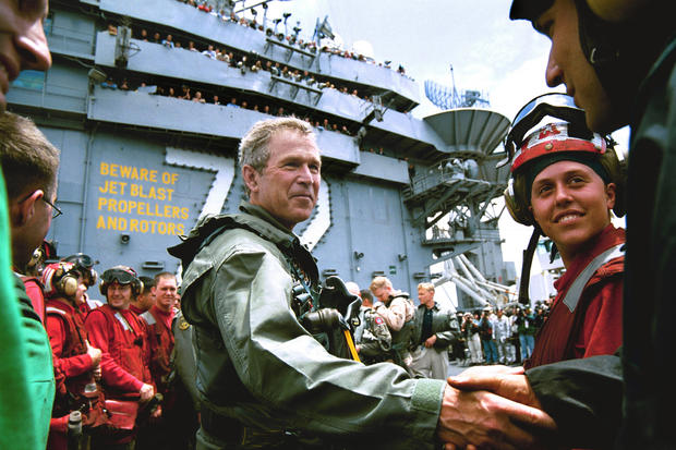 Bush_shaking_hands_in_flight_suit_on_USS_Abraham_Lincoln_(Pg._159)_1.jpg 
