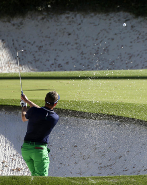 Luke Donald, of England, hits out of a bunker on the 12th hole during the second round of the Masters golf tournament April 12, 2013, in Augusta, Ga. 