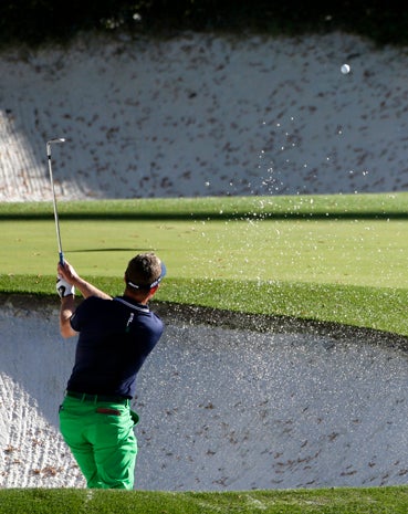 Luke Donald, of England, hits out of a bunker on the 12th hole during the second round of the Masters golf tournament April 12, 2013, in Augusta, Ga. 