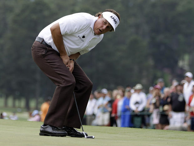 Phil Mickelson reacts after missing a putt on the 18th green during the first round of the Masters golf tournament April 11, 2013, in Augusta, Ga. 