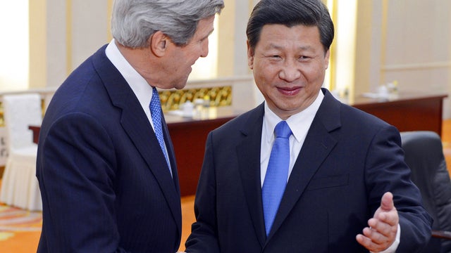 Chinese President Xi Jinping, right, poses with U.S. Secretary of State John Kerry before their meeting at the Great Hall of the People in Beijing April 13, 2013. 