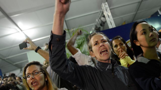 Supporters of Venezuelan presidential candidate Henrique Capriles react in Caracas on April 14, 2013 after officials said interim president Nicolas Maduro ha won presidency with 50.66 pct of votes in special election 
