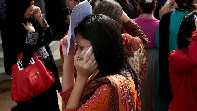 People evacuate buildings and call their relatives after an earthquake centered in neighboring Iran 