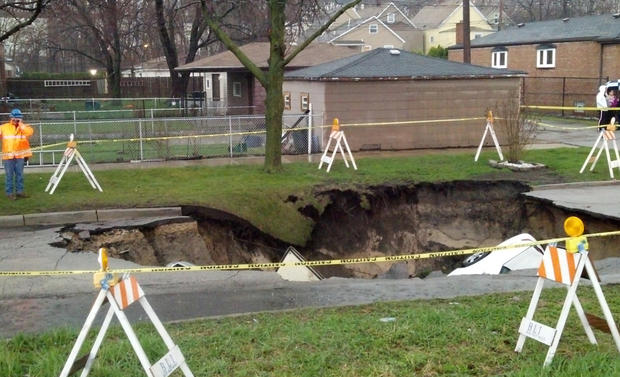 A sinkhole swallowed three cars on the Southeast Side of Chicago on, April 18, 2013 injuring one person. 