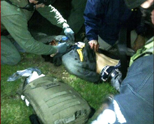 Dzokhar Tsarnaev lies on the ground after being detained by federal agents on Friday, April 19, 2013 