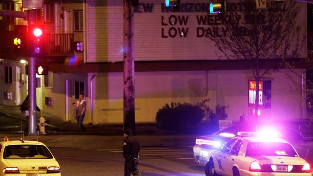 Washington State Patrol trooper directs driver away from street blocked off several blocks from scene of overnight shooting that police said left five people dead on April 22, 2013, at apartment complex in Federal Way, Wash., south of Seattle 