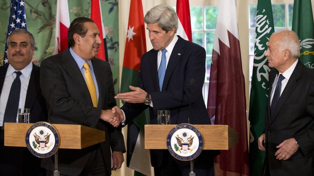 Secretary of State John Kerry, second from right, shakes hands with the Qatar's Prime Minister and Foreign Minister Hamad bin Jassim bin Jabr Al-Thani, second from left, who is leading the Arab League, following their meeting at Blair House in Washington, 