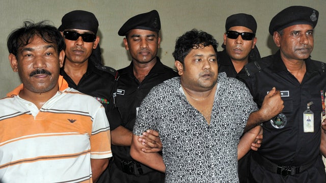 Mohammed Sohel Rana, center, the fugitive owner of an illegally-constructed building that collapsed last week, killing some 377 people, is paraded by Rapid Action Battalion commandoes along with his unidentified alleged accomplices, seen at left, in Dhaka 