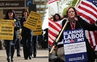 US Airways union workers appear at left of members of American Airlines' unions 