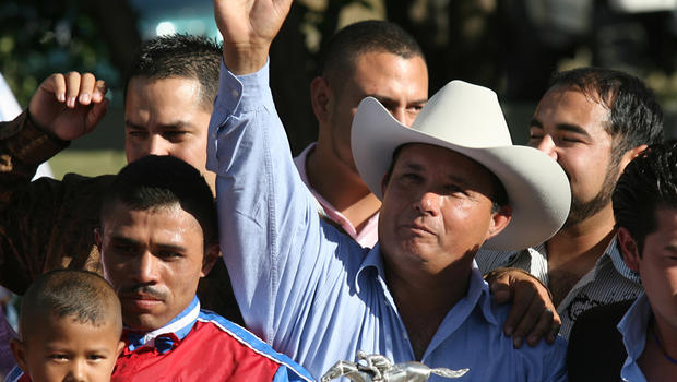 In this Sept. 6, 2010 file photo, owner Jose Trevino Morales, center, acknowledges the crowd as he stood with the trophy after Mr. Piloto won the All American Futurity horse race at Ruidoso Downs, N.M. Prosecutors told a federal jury on Wednesday, May 8, 2013 that Morales, the man they say is the brother of leaders of Mexico's most blood-soaked criminal organization, used the proceeds from their brothers' ill-gotten gains to bankroll his horse-racing stable. 