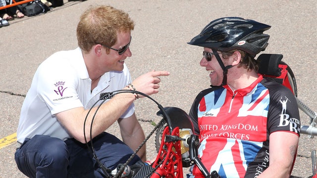 Prince Harry speaks to competitors as he attends the US airforce training academy hand cycling event at the Warrior Games during the fourth day of his visit to the United States on May 12, 2013 in Colorado Springs, Colorado. 